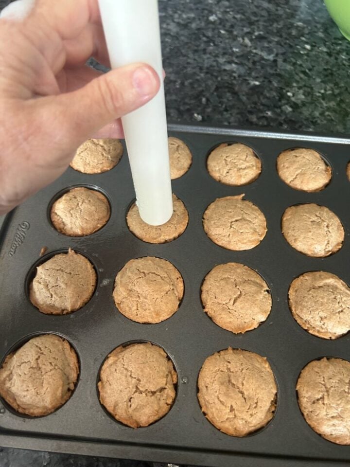 Spice Cake Bites being welled out with tool