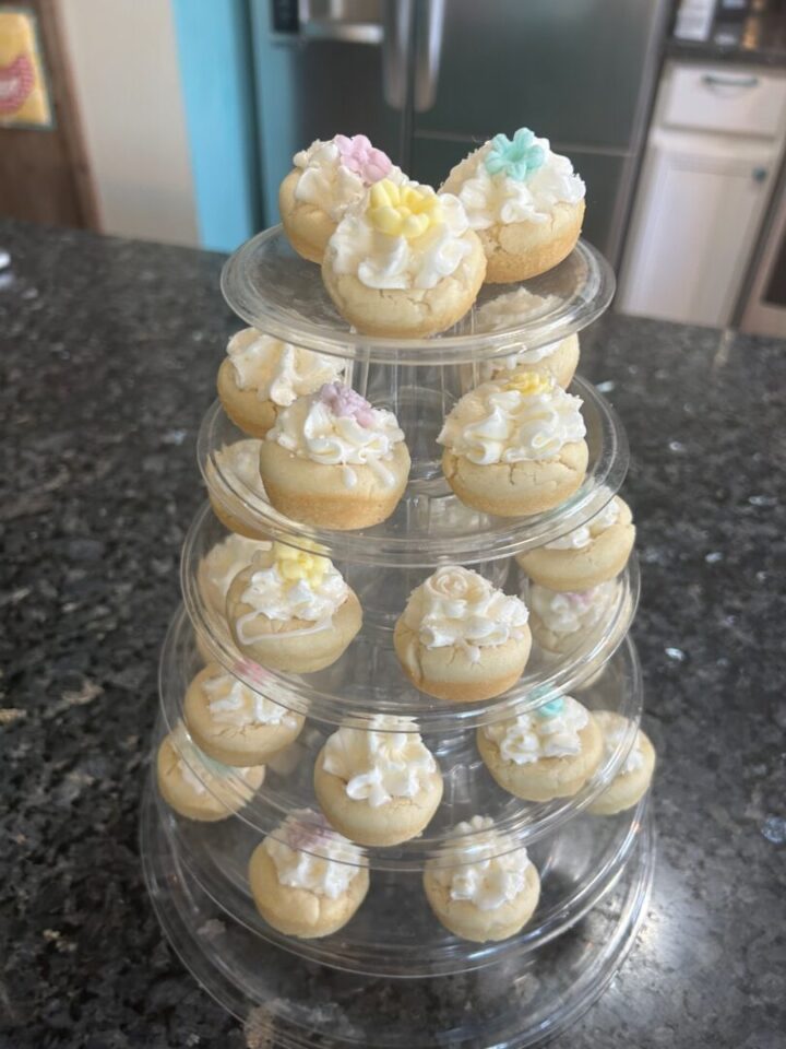 decorated almond cookie cups on tiered stand