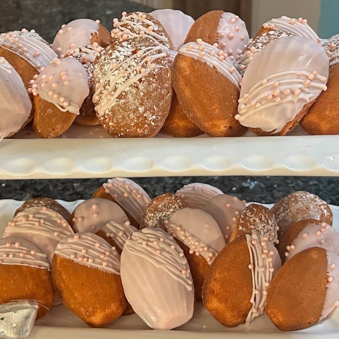 beautifully decorated cake mix madeleines in shades of pink and white on trays