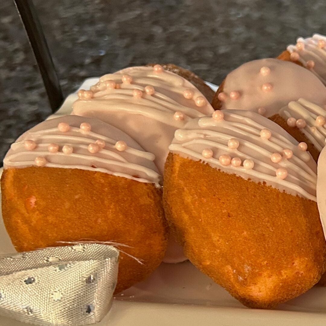 beautifully decorated cake mix madeleines in shades of pink and white on trays