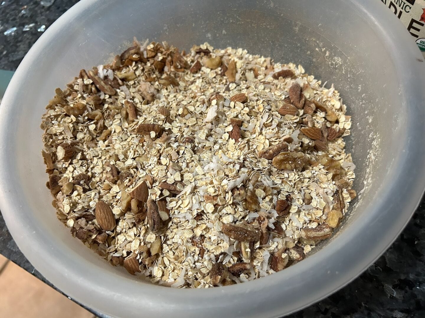 granola mixed in bowl before baking