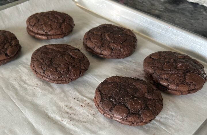 chocolate cookies in pairs on cookie sheet