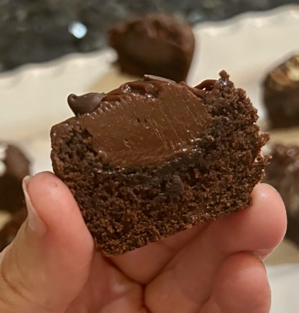 chocolate ganache piped into cake bite, truffle consistency
