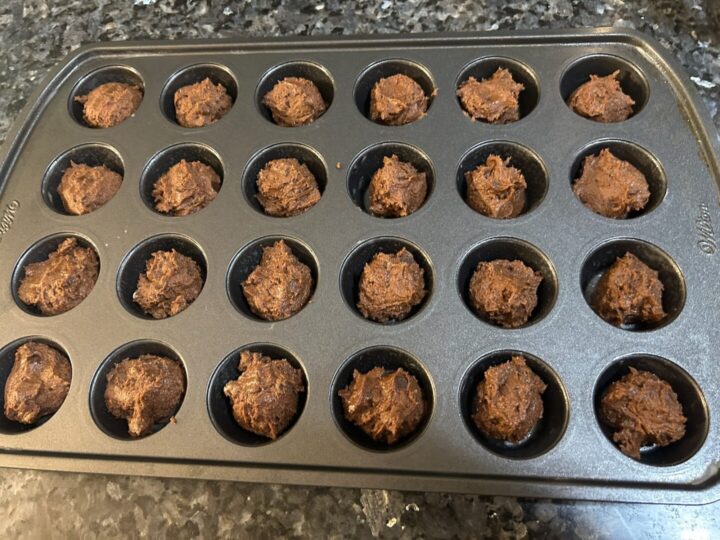 chocolate cookie dough in muffin tin