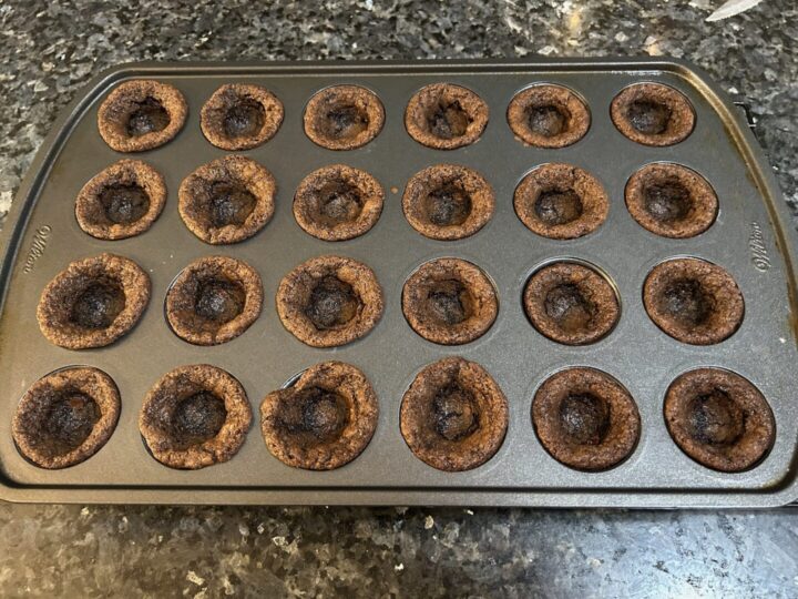 chocolate cookie cups in muffin tin