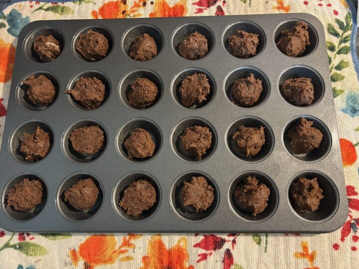 scooped cookie dough in mini muffin pan