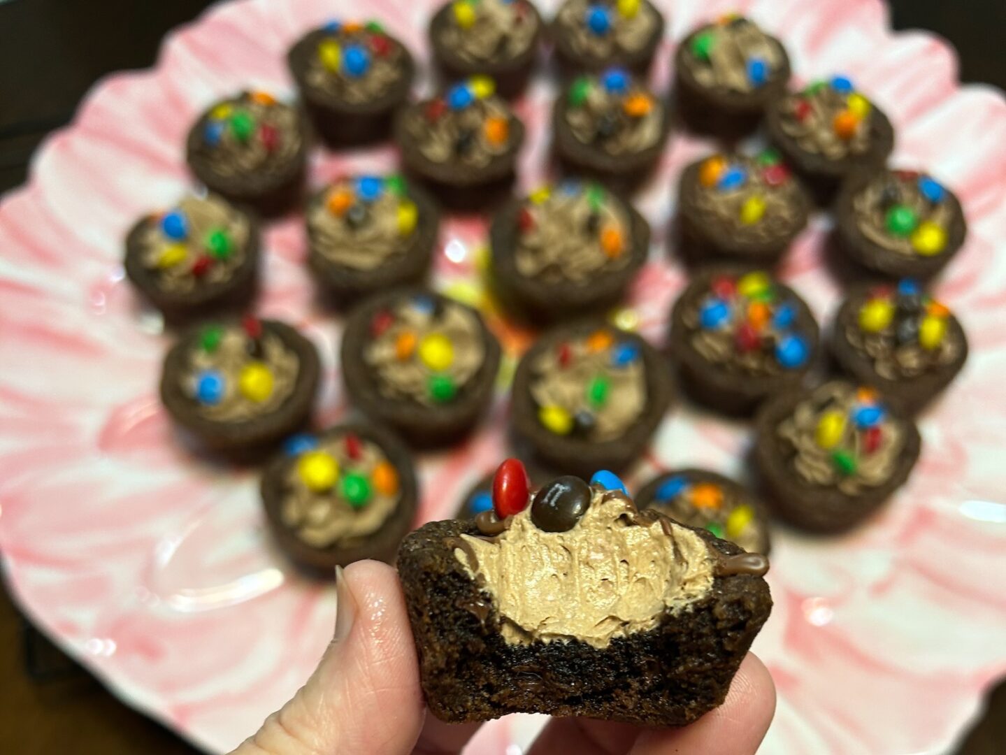 chocolate cookie cups filled with chocolate marshmallow fluff frosting and topped with mini M&Ms (interior view)