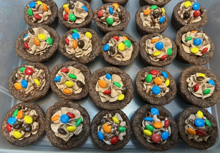 chocolate cookie cups filled with chocolate marshmallow fluff frosting and topped with mini M&Ms