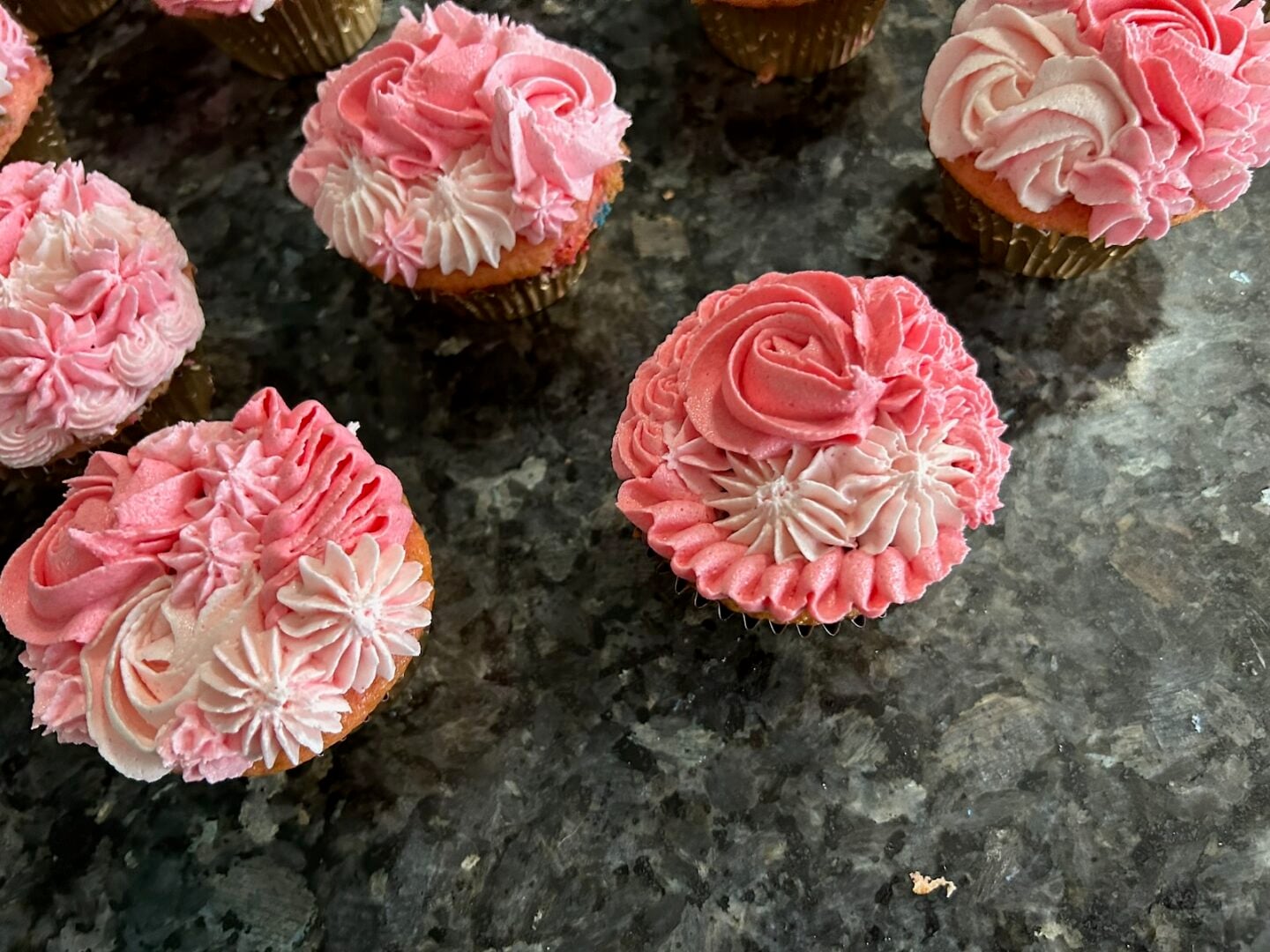 pink ombre cupcakes piped with a variety of tips: rosettes, ruffles, and puffs