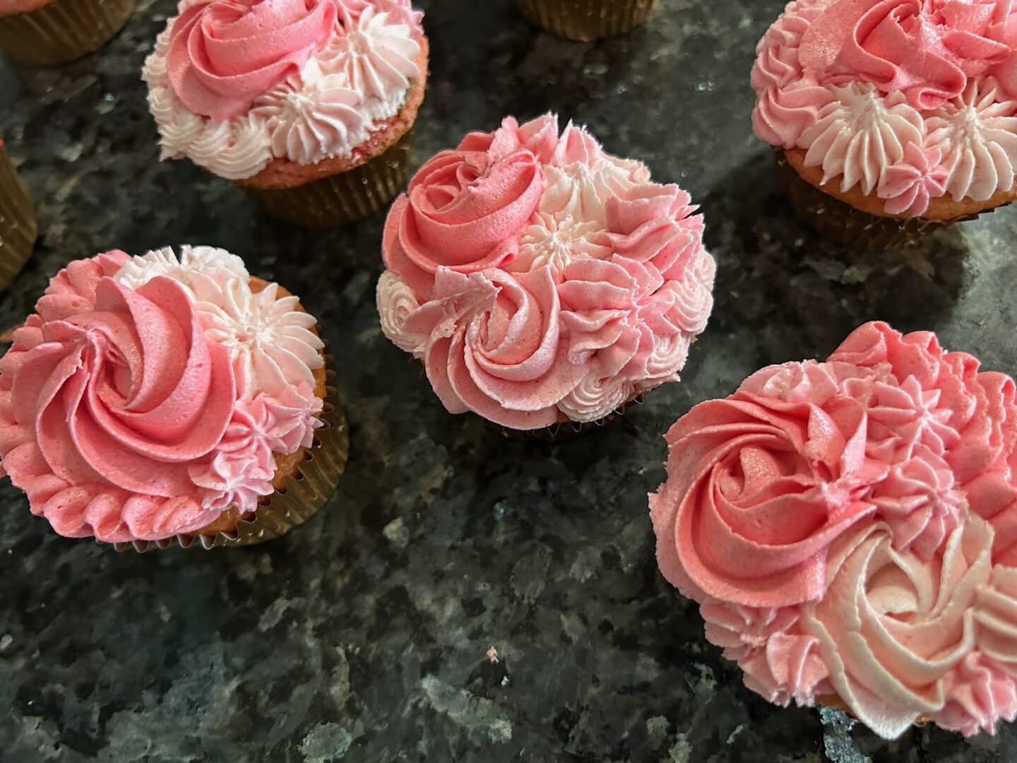 pink ombre cupcakes piped with a variety of tips: rosettes, ruffles, and puffs