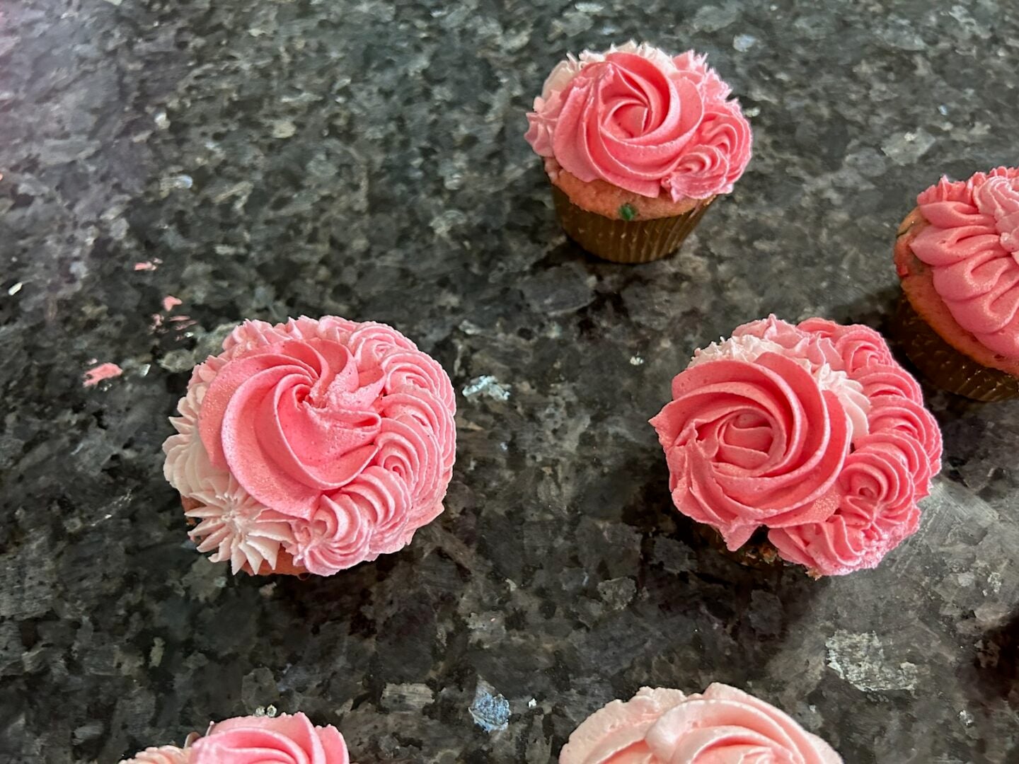 pink ombre cupcakes piped with a variety of tips: rosettes, ruffles, and puffs