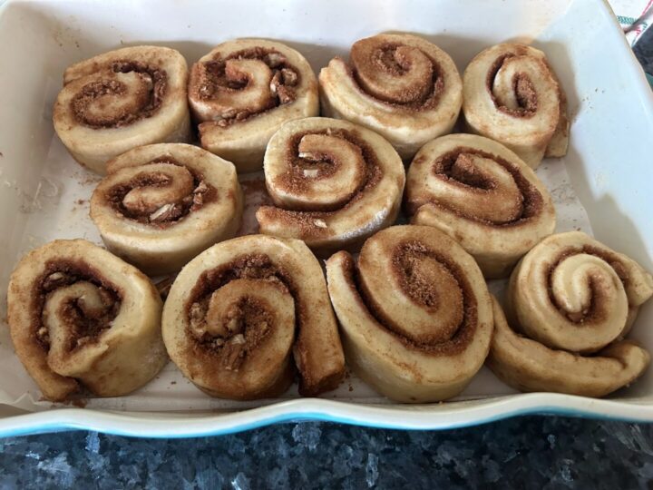 cinnamon rolls in pan after rising