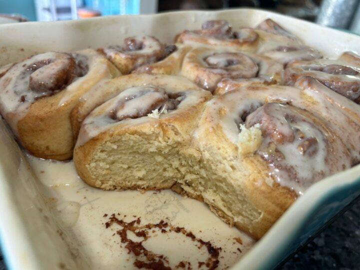 pan of cake mix cinnamon rolls with one removed, interior view, soft and flaky