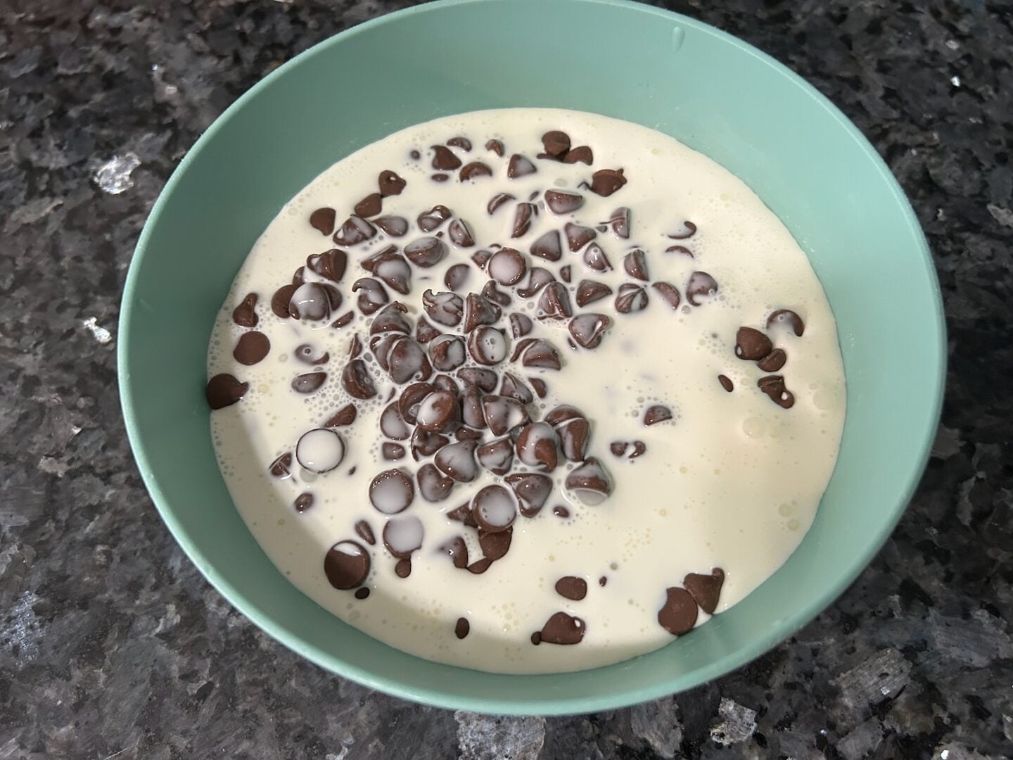making chocolate ganache (chips and cream in bowl)
