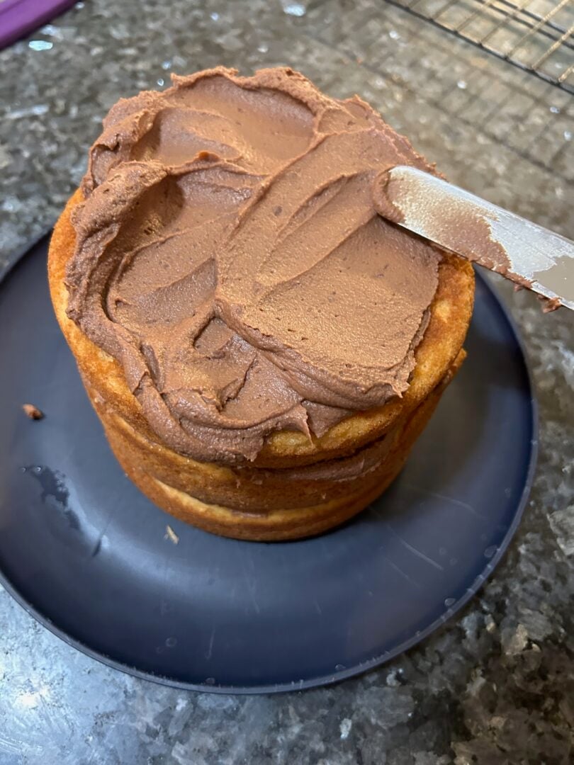 whipped chocolate ganache frosting spread on cake