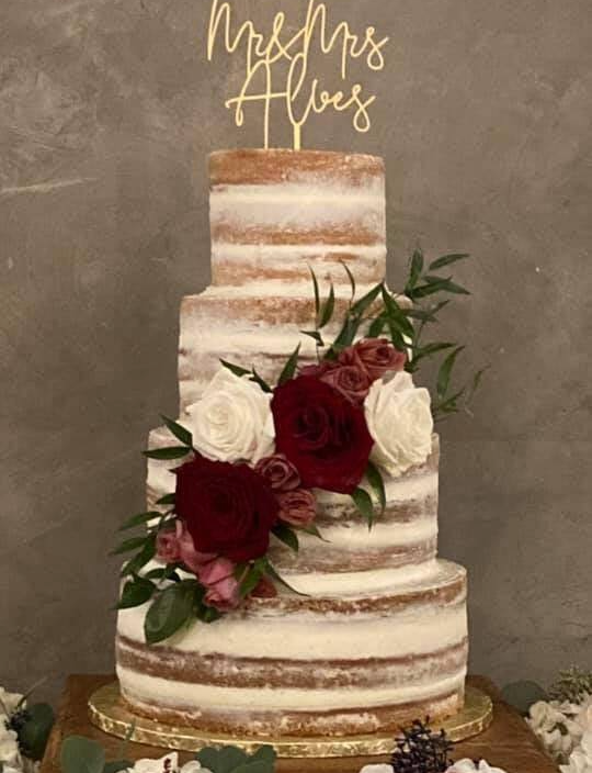gorgeous wedding cake, naked cake with maroon and white flowers