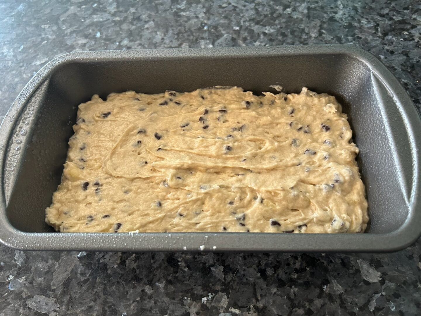 banana bread batter with chocolate chips in 9x5" pan