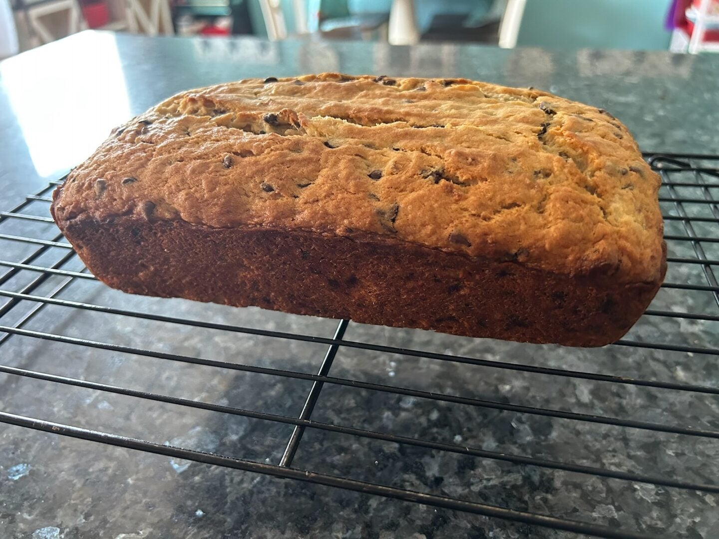 baked banana bread with chocolate chips on wire rack