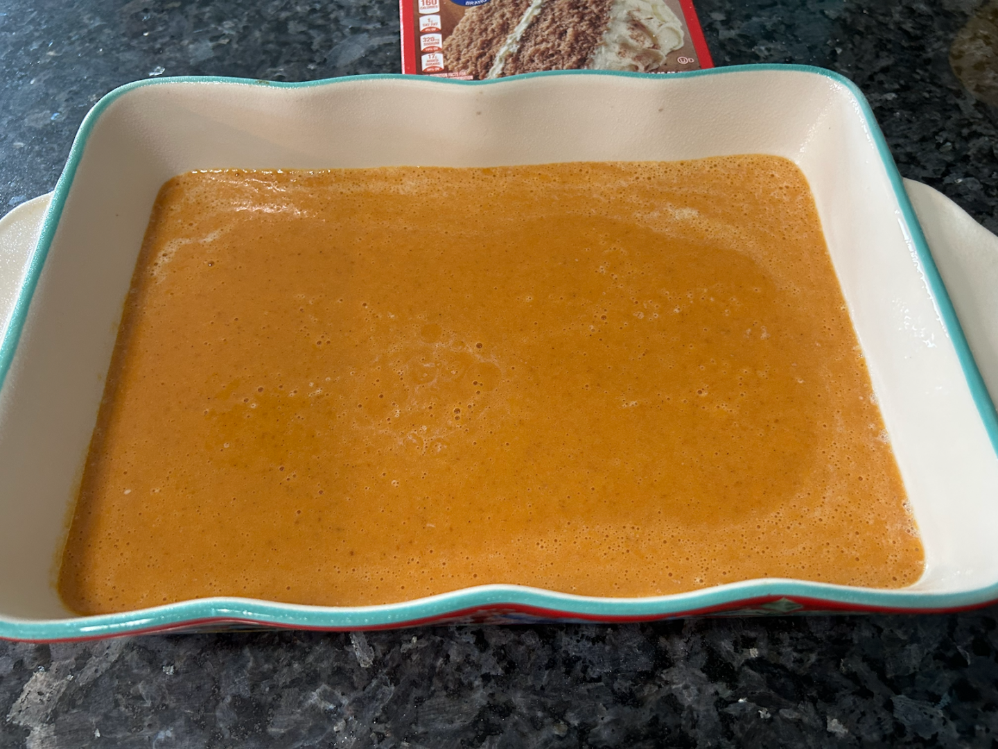 Easy Pumpkin Dump Cake with Spice Cake Mix liquid ingredients in casserole dish