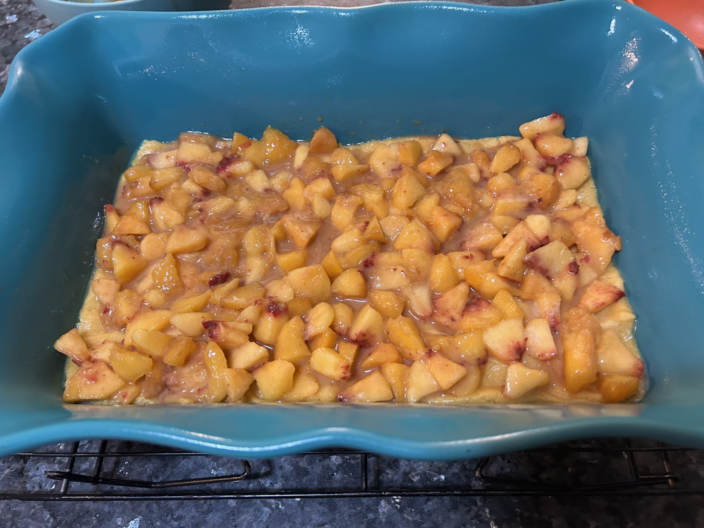 diced peaches on top of crust