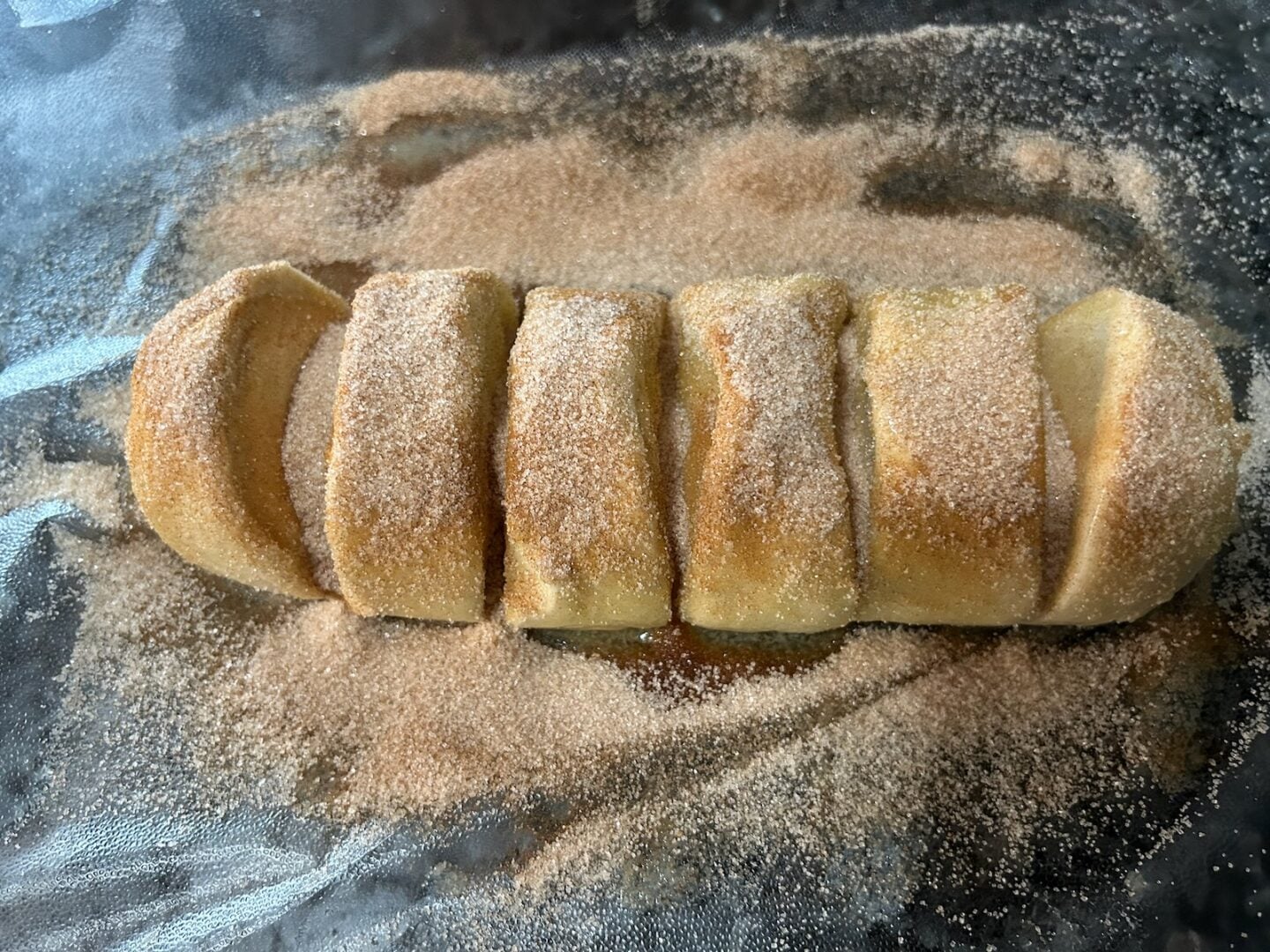 covering bread dough in butter and cinnamon sugar