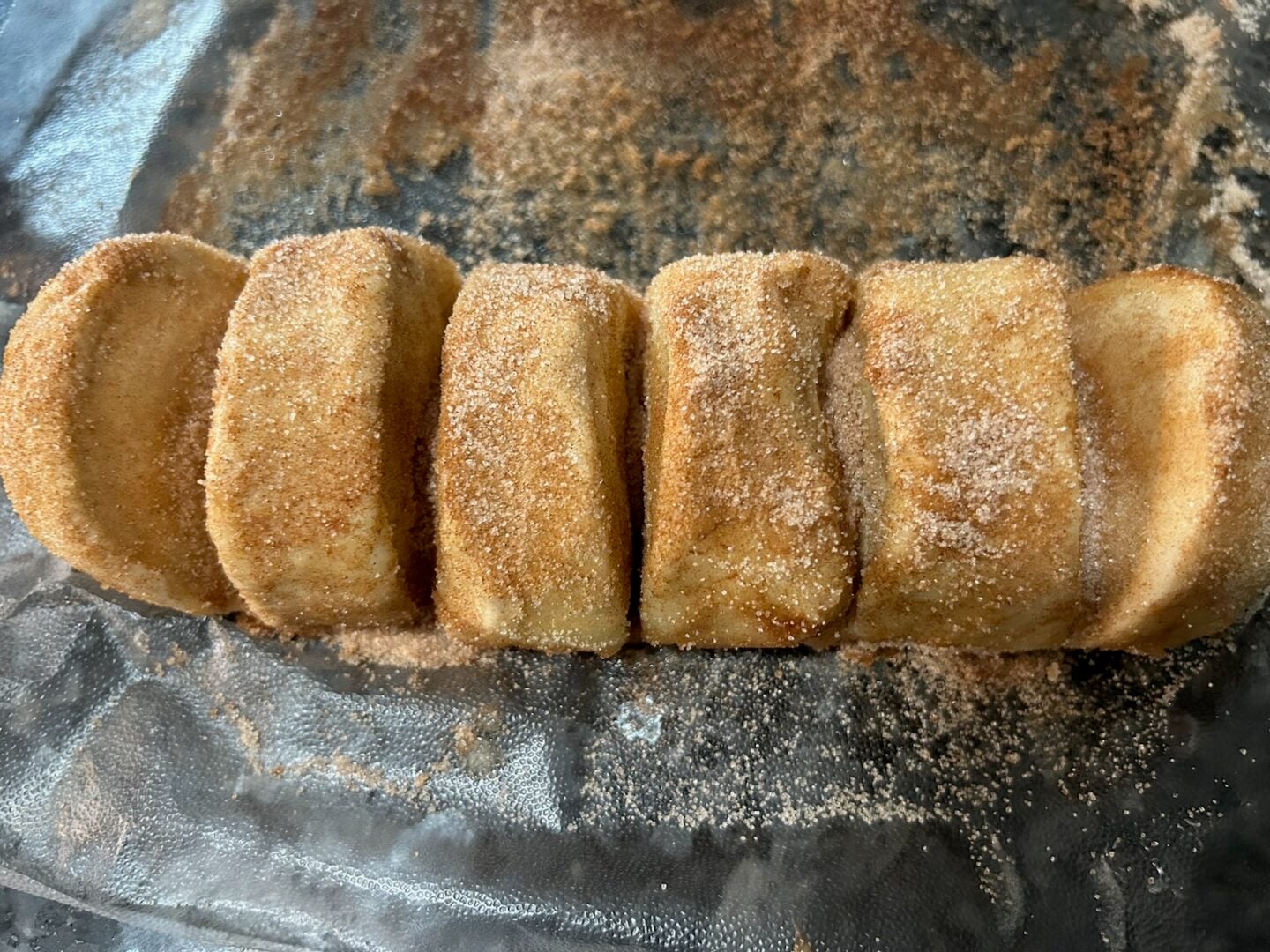 covering bread dough in butter and cinnamon sugar