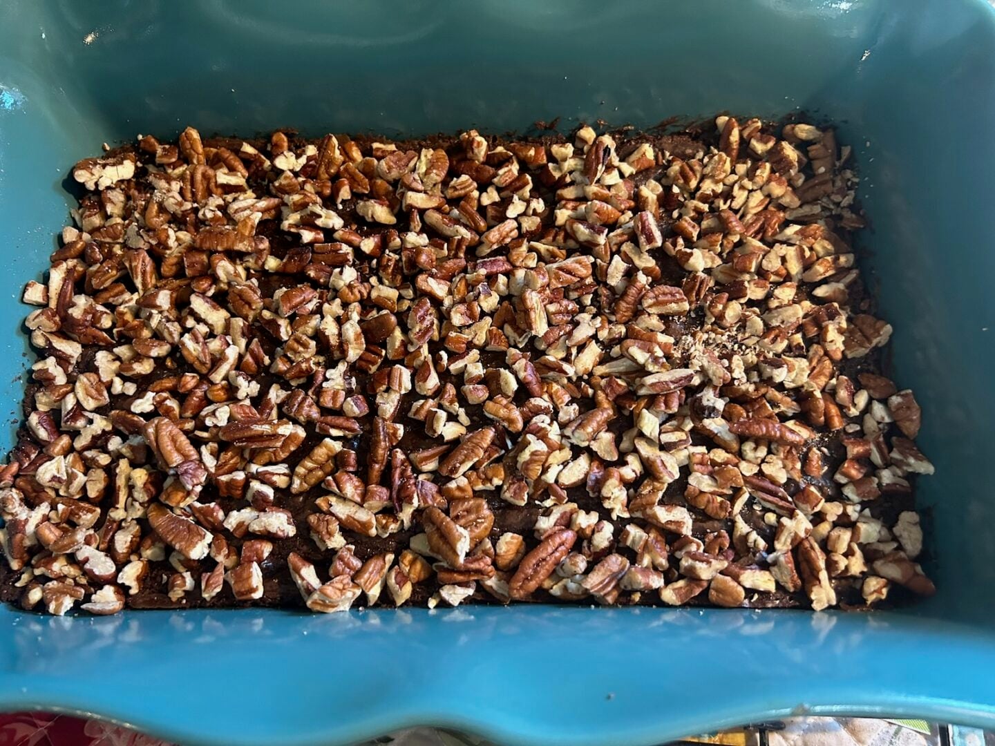 pecans spread on baked brownies