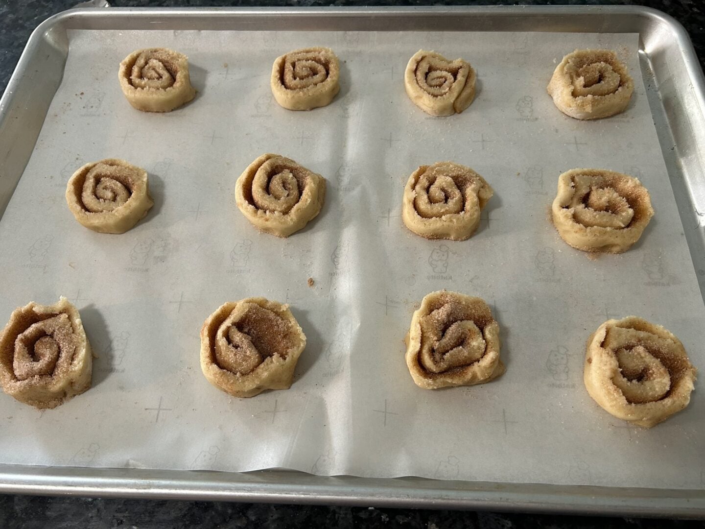 sugar cookie pinwheels cut and placed on cookie sheet