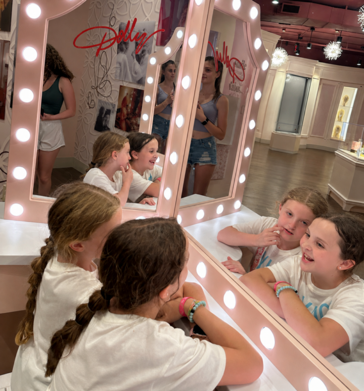girls pretending to put on makeup at Dollywood in dolly's dressing area