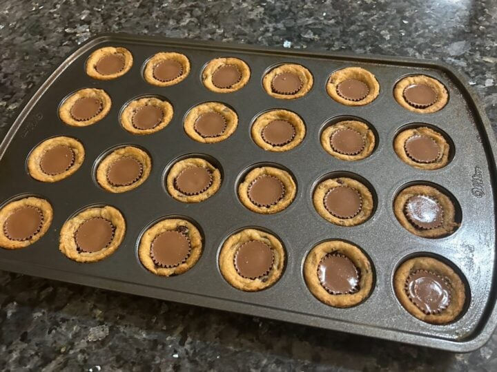 2-ingredient Reese's chocolate chip cookie cups cooling in pan