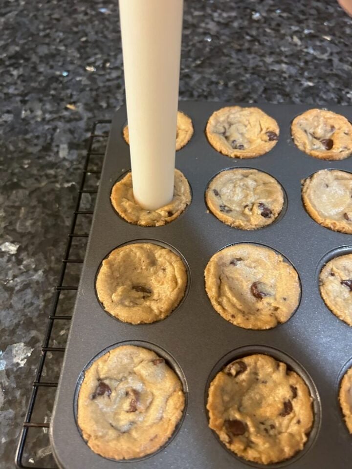 Easy Salted Caramel Chocolate Chip Cookie Cups being shaped in pan