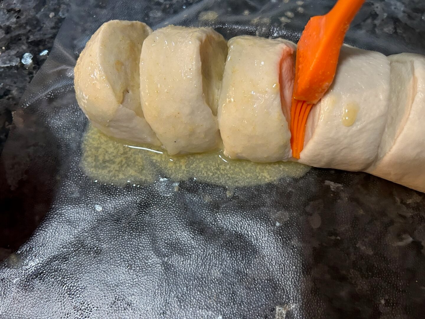 buttering the bread dough
