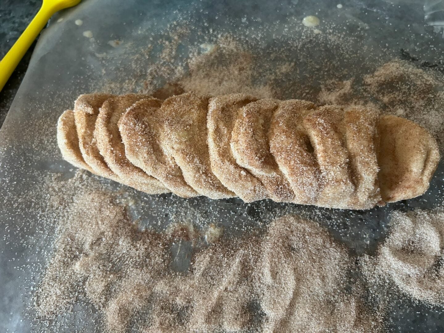 adding cinnamon sugar to bread dough loaf