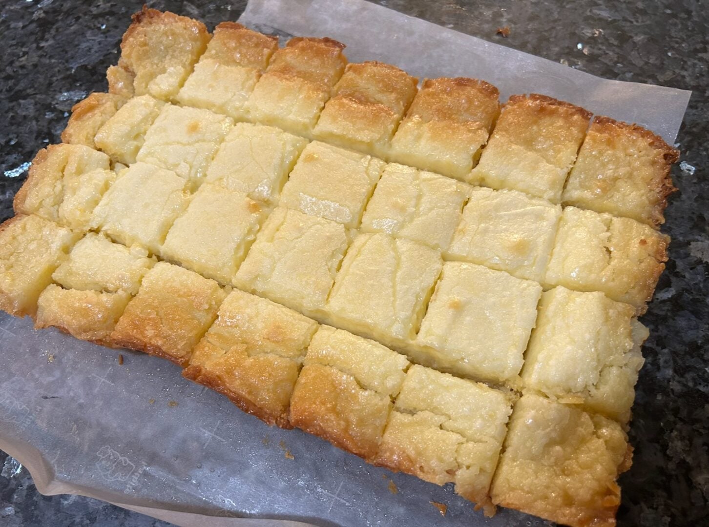 Lemon gooey butter cake sliced