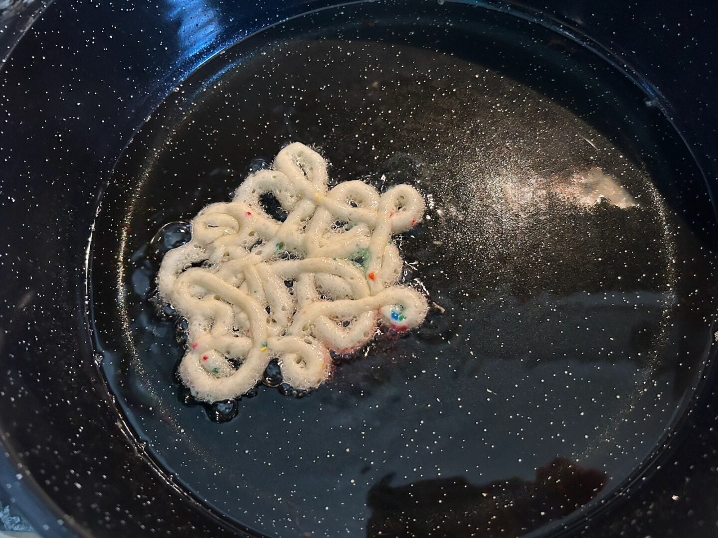 funnel cake frying in skillet