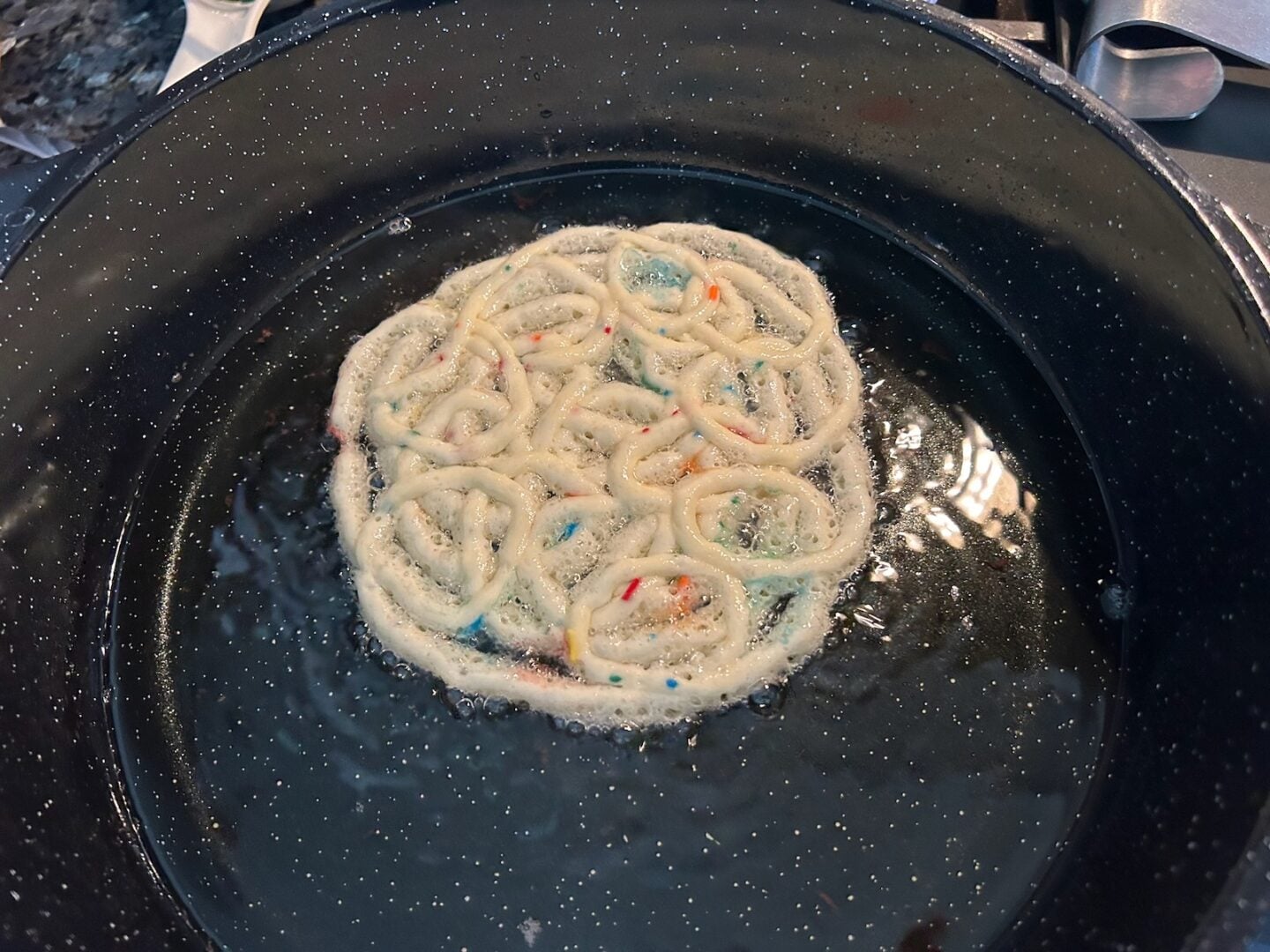 funnel cake frying in skillet