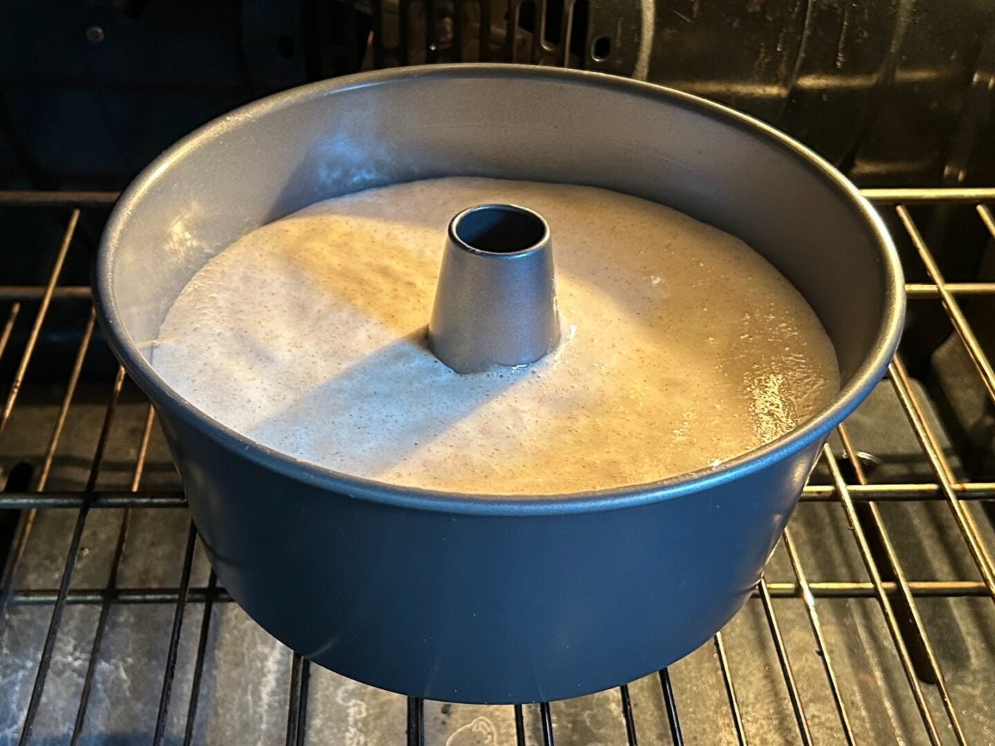 angel food cake batter in pan in oven