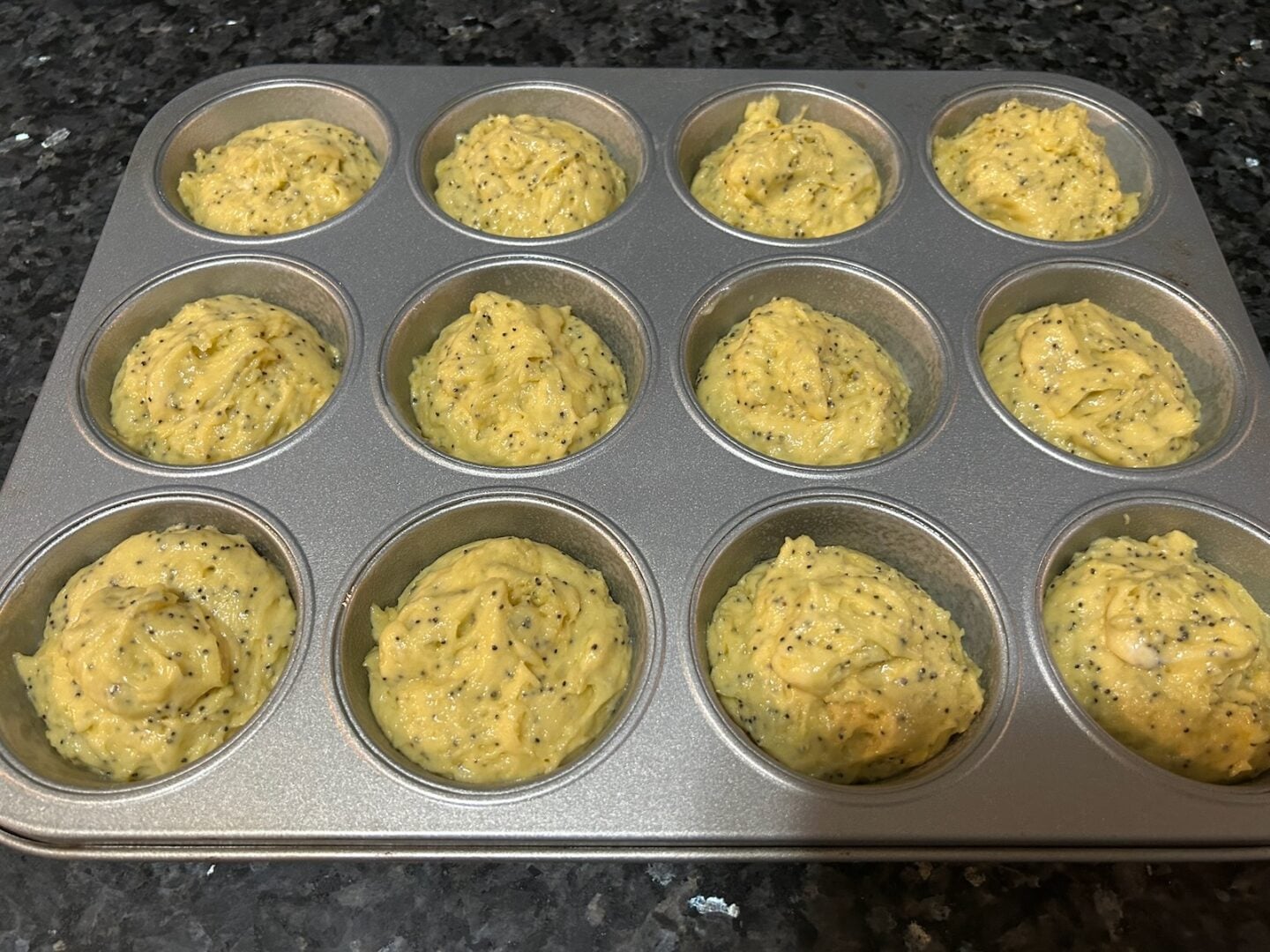 lemon poppyseed muffin batter in pan