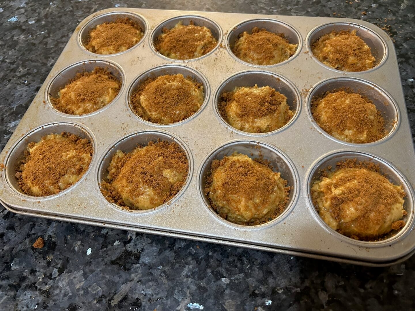 muffin batter with topping in pan