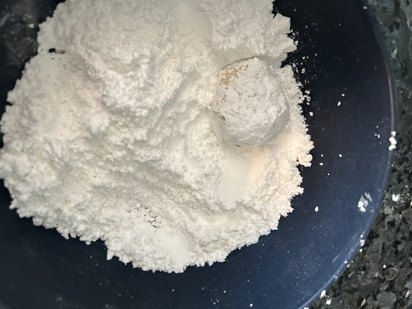 cookie dough ball rolled in powdered sugar