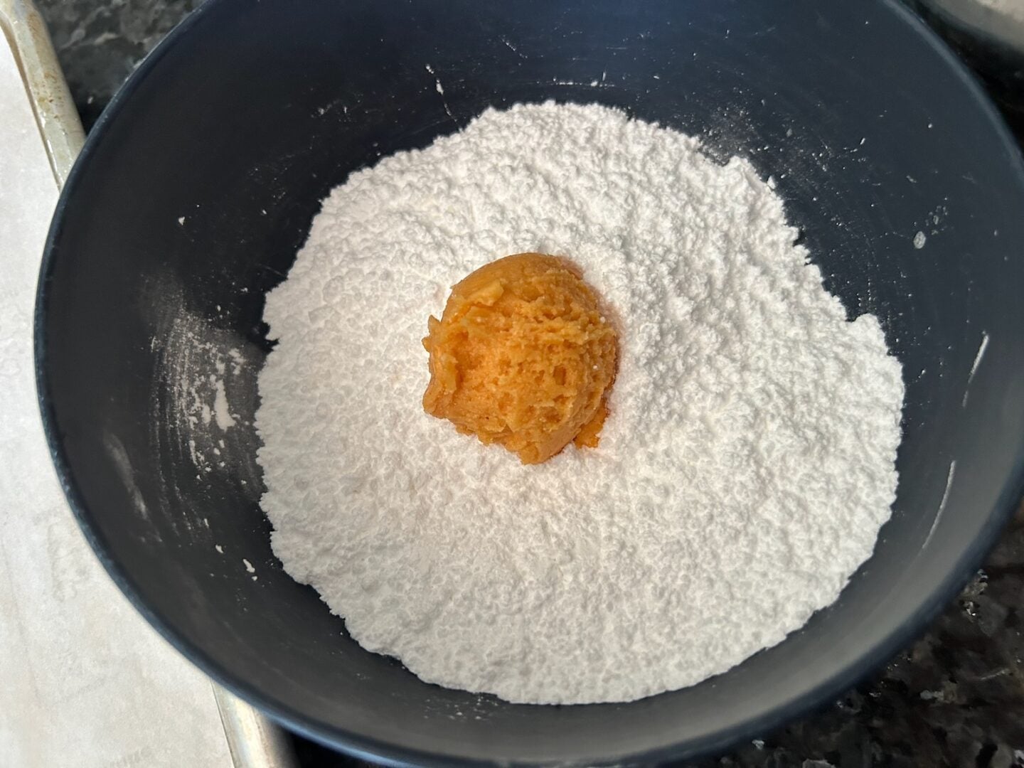 cookie dough ball in powdered sugar