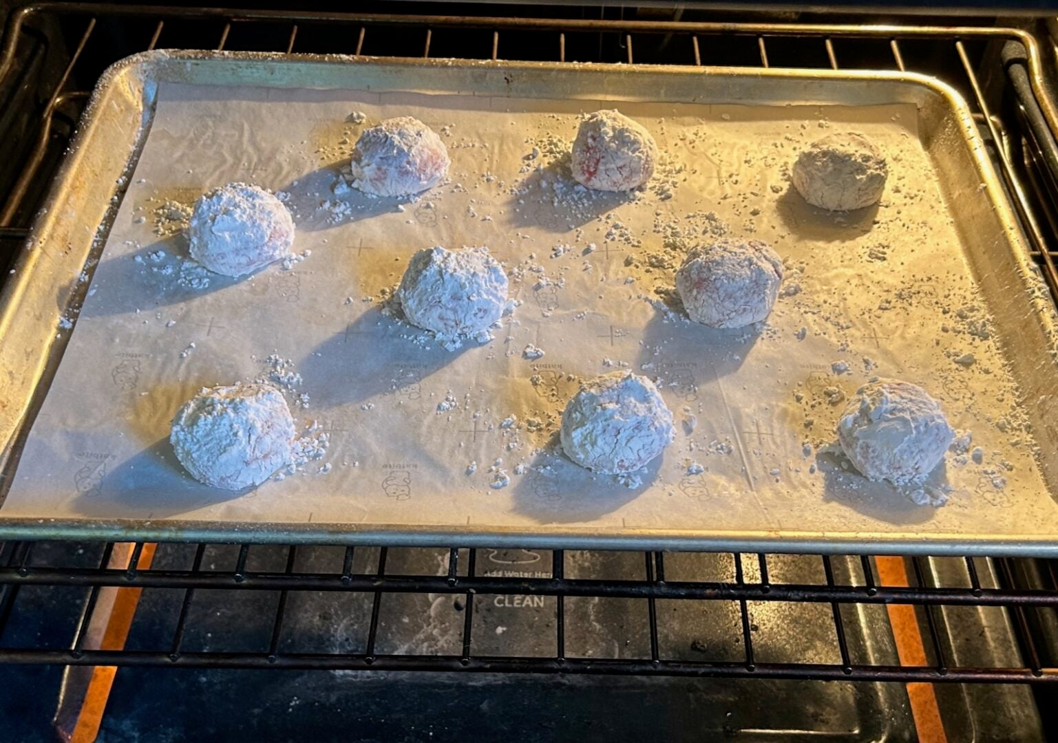 Easy Strawberry Crinkle Cookies (Cake Mix Recipe) dough balls on cookie sheet in oven