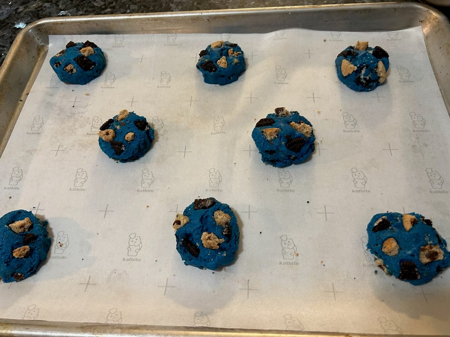 blue cookie dough balls with broken Oreos and chips ahoy inserted