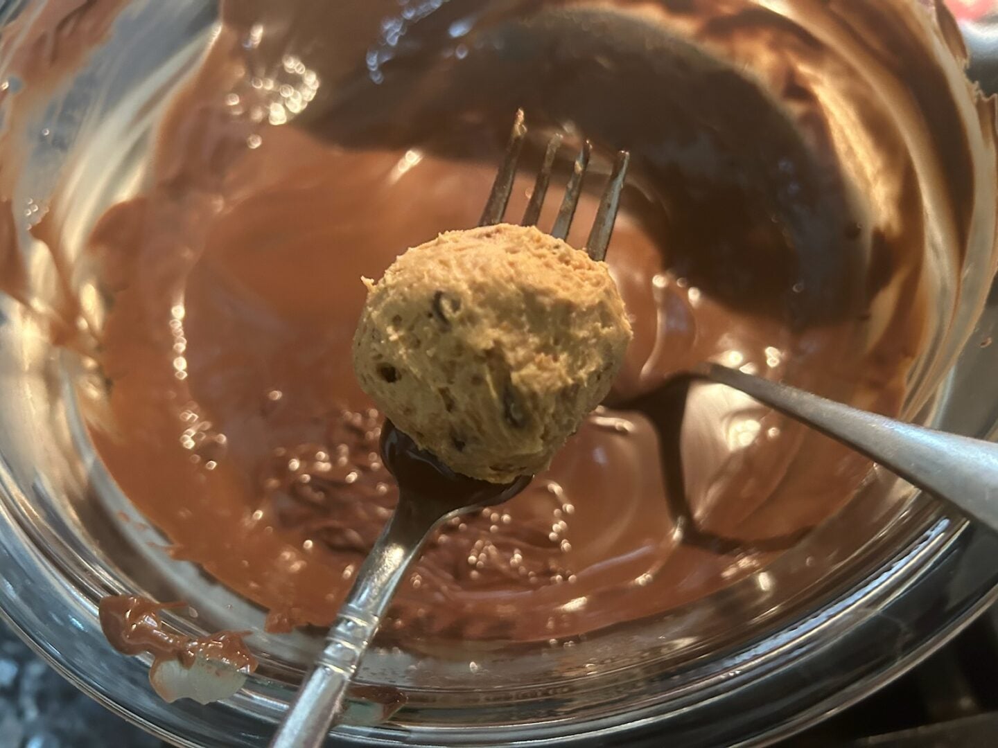 coating truffle in melted chocolate